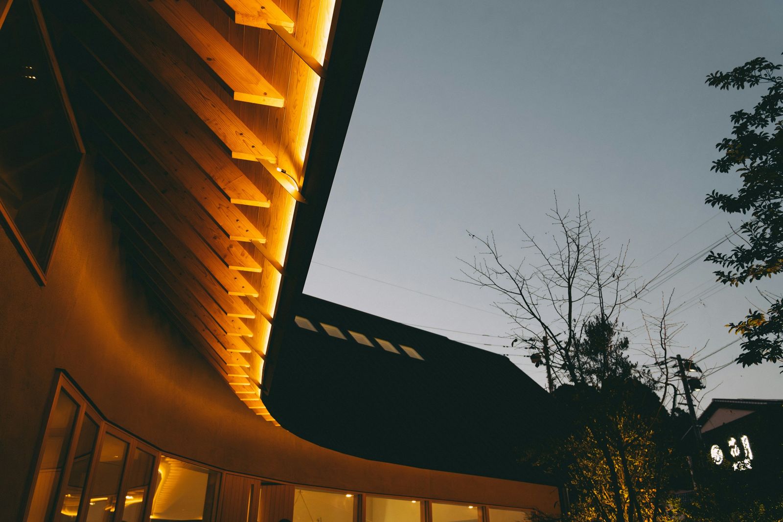 Building exterior glowing with warm light at dusk